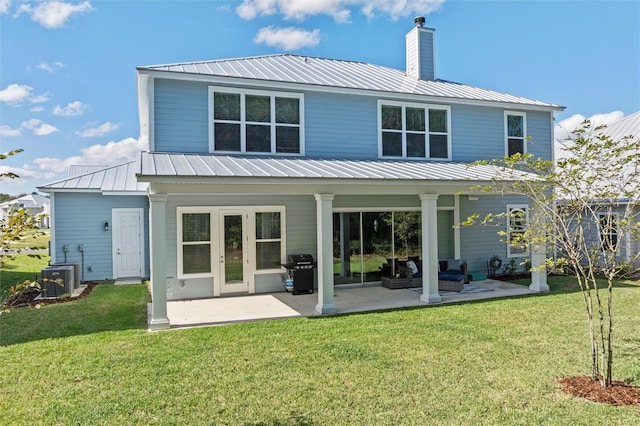 back of property featuring french doors, a yard, cooling unit, and a patio area