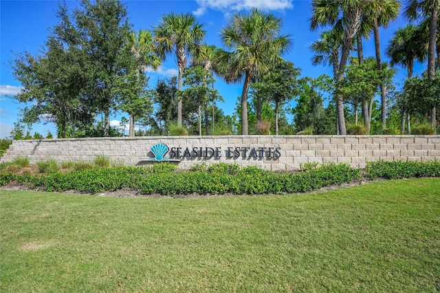 community sign featuring a lawn