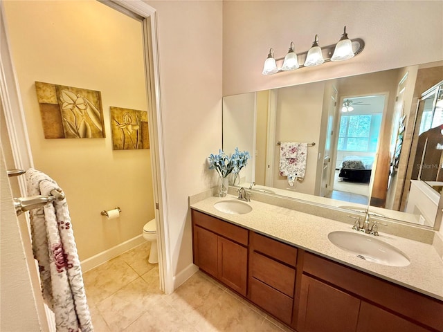 bathroom featuring tile patterned floors, ceiling fan, vanity, and toilet