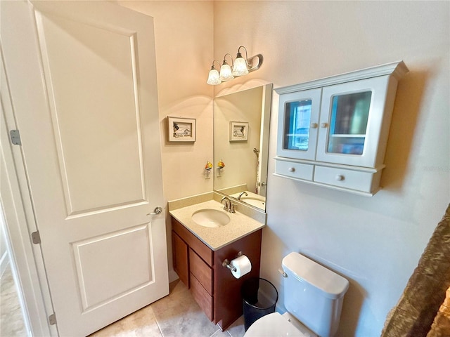 bathroom with tile patterned flooring, vanity, and toilet