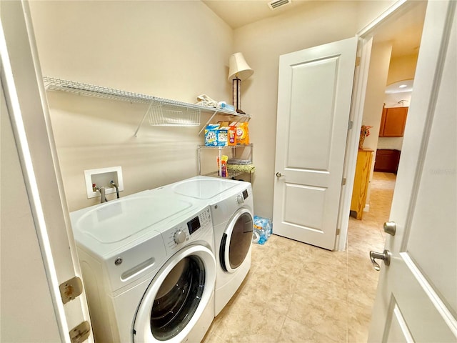 laundry area with washing machine and clothes dryer