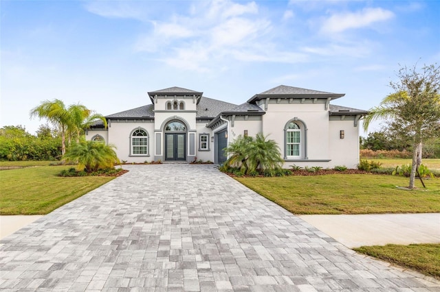 mediterranean / spanish home featuring french doors and a front lawn