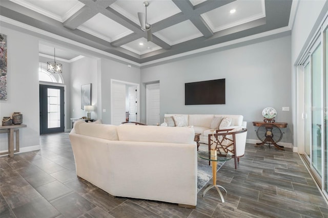 living room featuring beamed ceiling, dark hardwood / wood-style floors, ornamental molding, and coffered ceiling