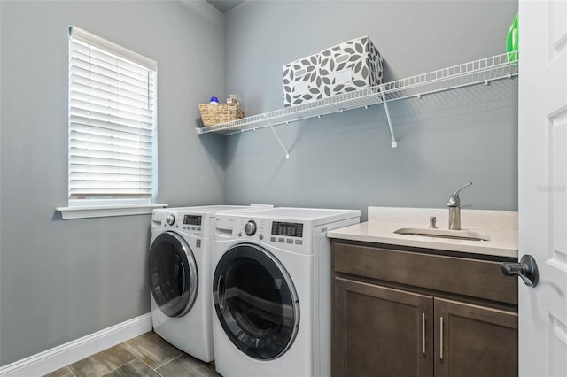 washroom featuring separate washer and dryer, cabinets, sink, and dark wood-type flooring