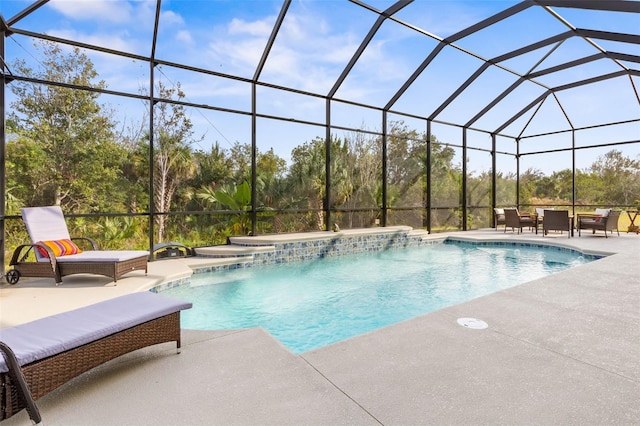 view of pool with pool water feature, a patio area, and a lanai