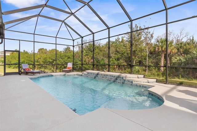 view of swimming pool with a lanai, pool water feature, and a patio