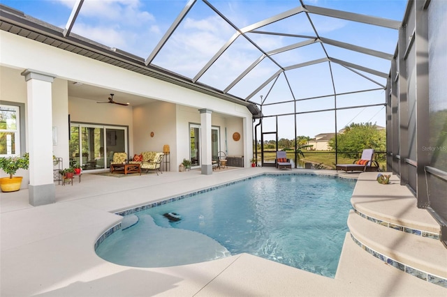 view of swimming pool featuring a lanai, a patio area, and ceiling fan