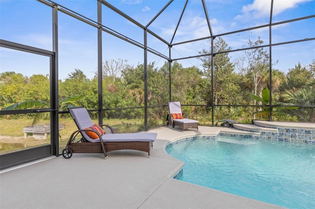 view of swimming pool with a patio area and glass enclosure