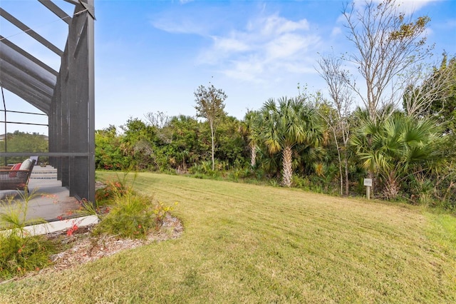 view of yard featuring glass enclosure