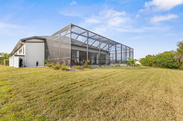 back of property featuring a lawn and a lanai