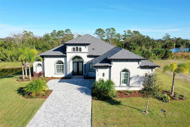 view of front of house with french doors and a front lawn