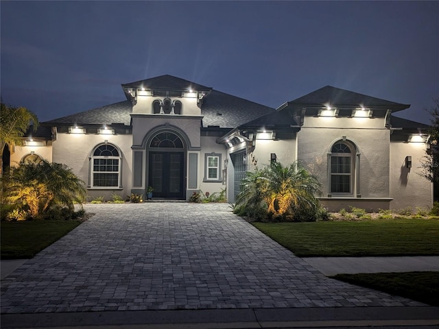 view of front of home with a yard and french doors