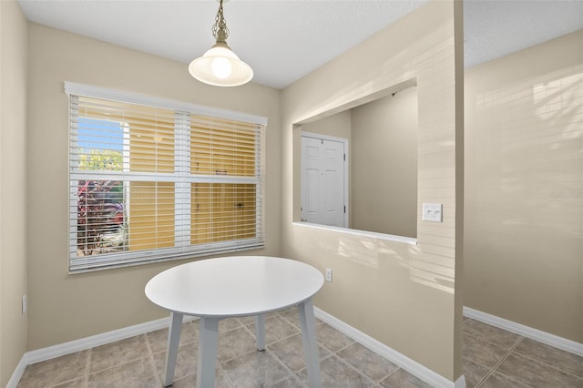 dining space with tile patterned flooring