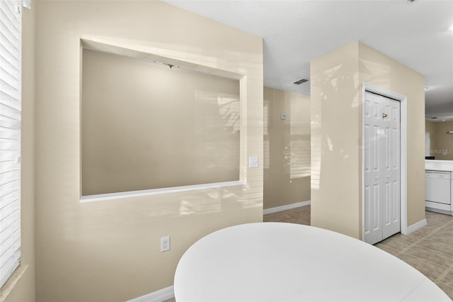 bathroom featuring tile patterned flooring and a bathtub