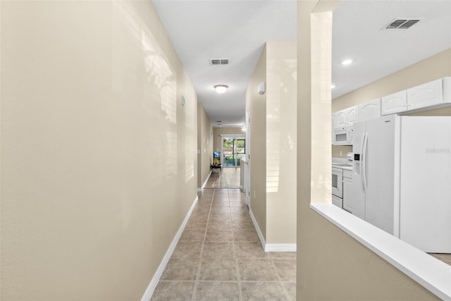 hallway with light tile patterned flooring