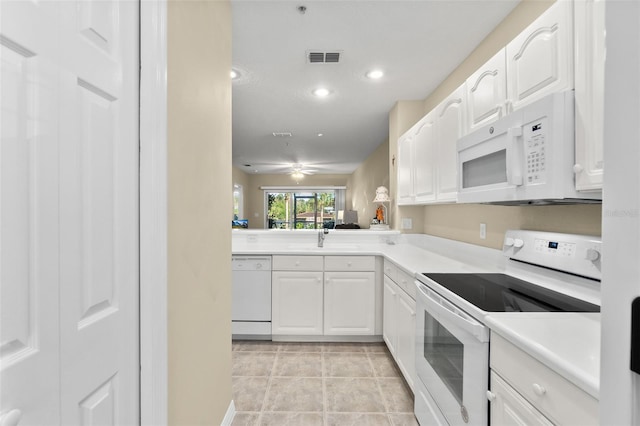 kitchen featuring white cabinetry, sink, kitchen peninsula, white appliances, and light tile patterned floors