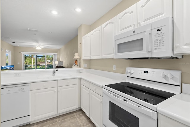 kitchen featuring white cabinetry, white appliances, kitchen peninsula, and light tile patterned floors