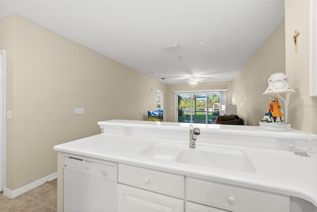 kitchen with white cabinets, ceiling fan, sink, light tile patterned floors, and dishwasher