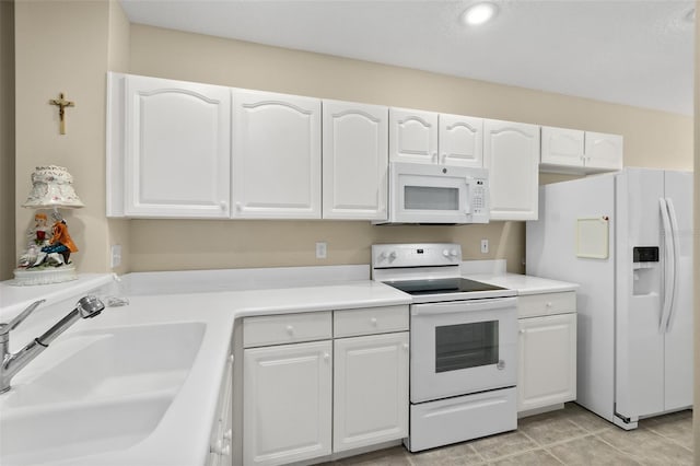 kitchen featuring white cabinets, white appliances, sink, and light tile patterned floors