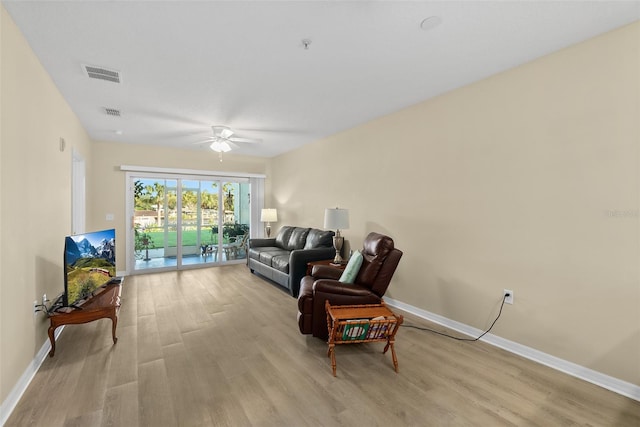 living area with ceiling fan and light hardwood / wood-style floors