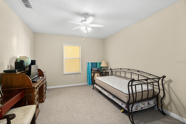 carpeted bedroom with a textured ceiling and ceiling fan