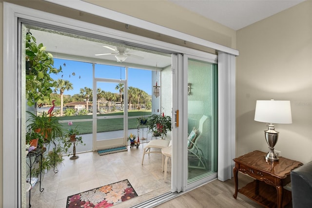 doorway featuring light hardwood / wood-style flooring and ceiling fan