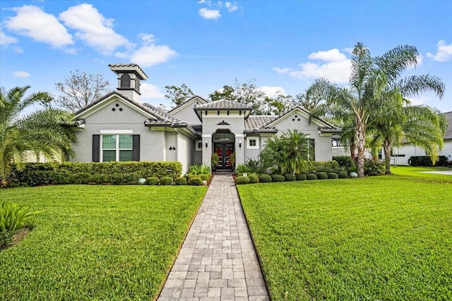 mediterranean / spanish-style home featuring a front yard