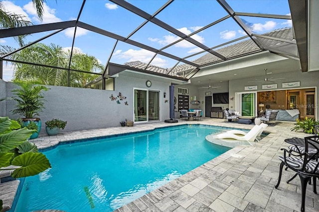 view of pool featuring ceiling fan, a patio, and glass enclosure