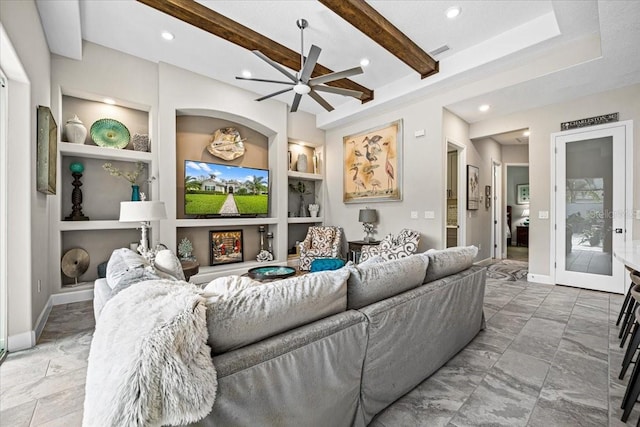 living room featuring beamed ceiling, built in shelves, and ceiling fan