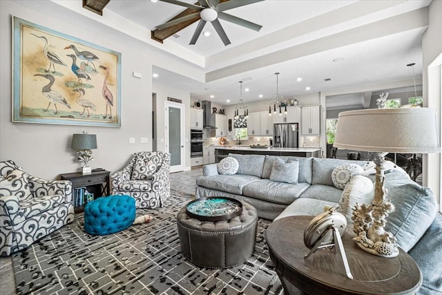 living room with ceiling fan with notable chandelier