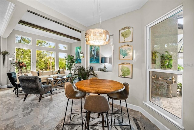 dining area featuring a chandelier and beamed ceiling