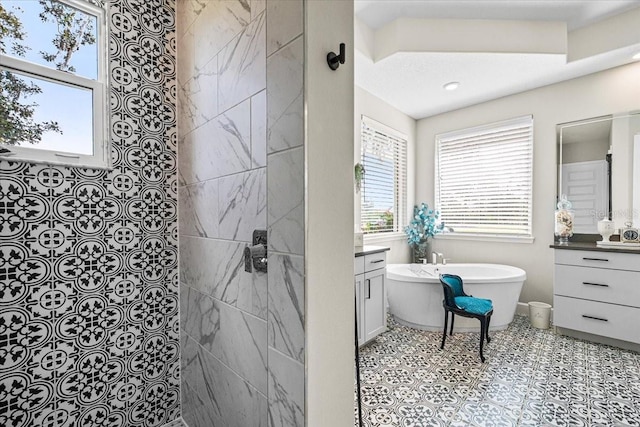 bathroom featuring tile patterned flooring, shower with separate bathtub, and vanity