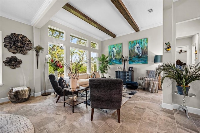 sunroom with ceiling fan and beamed ceiling