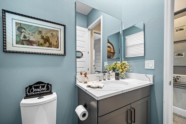 bathroom with vanity and toilet