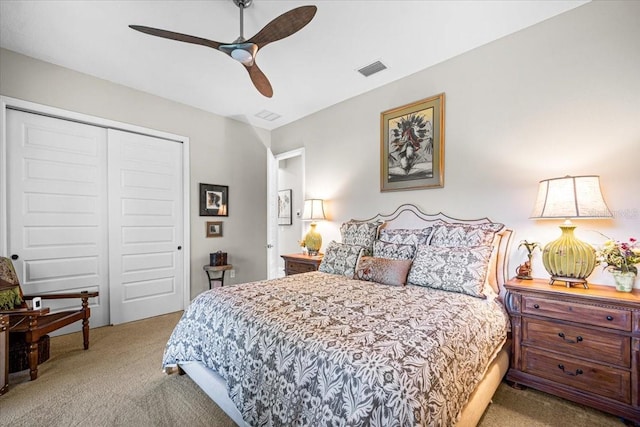 carpeted bedroom featuring ceiling fan and a closet