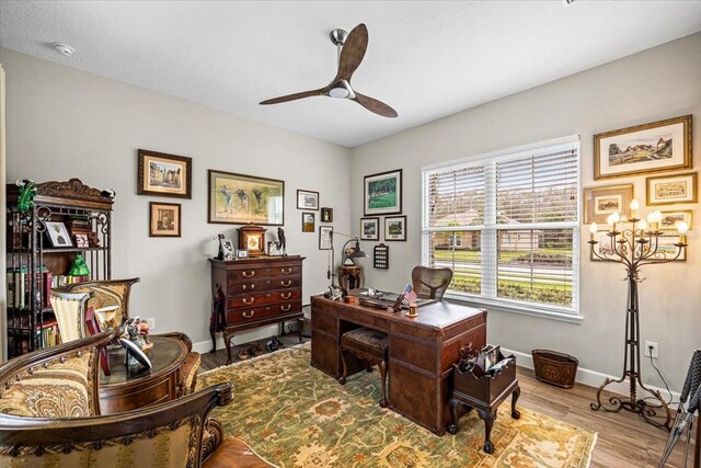 office area with light hardwood / wood-style floors and ceiling fan