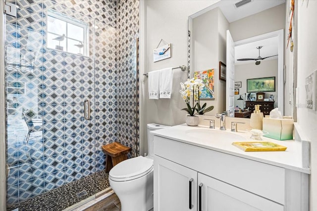 bathroom with hardwood / wood-style flooring, vanity, toilet, and walk in shower