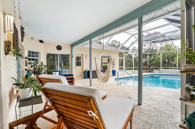 view of swimming pool featuring glass enclosure and a patio area