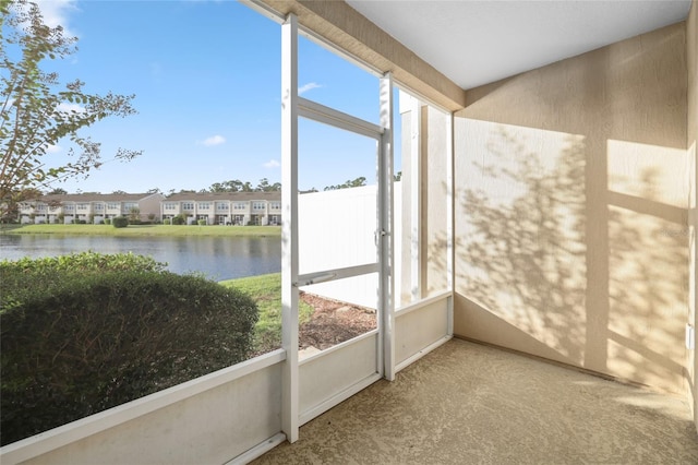 unfurnished sunroom featuring a water view and plenty of natural light