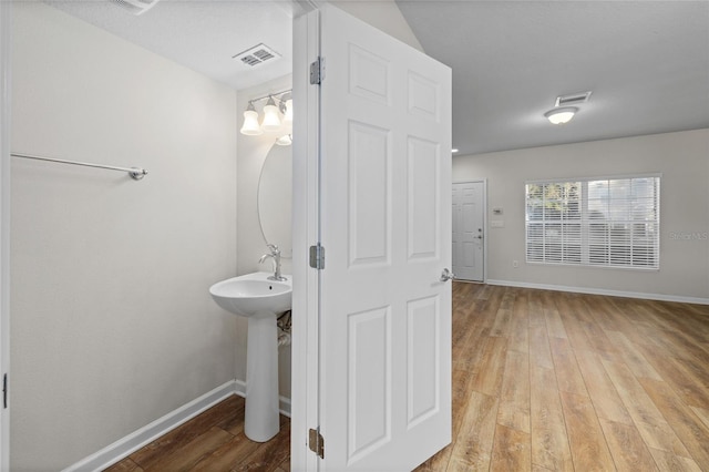 bathroom with hardwood / wood-style flooring