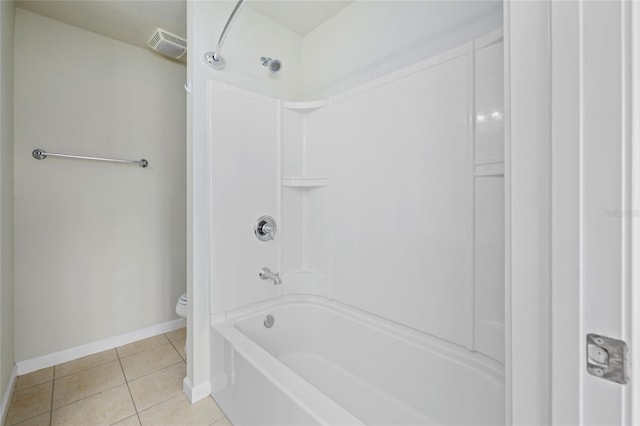 bathroom with toilet, shower / bath combination, and tile patterned floors