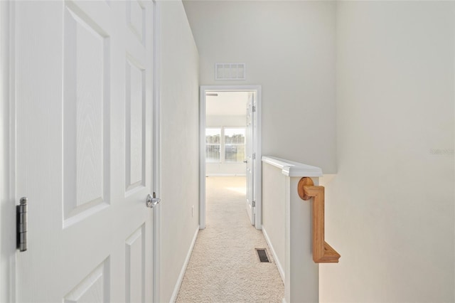 corridor with light colored carpet