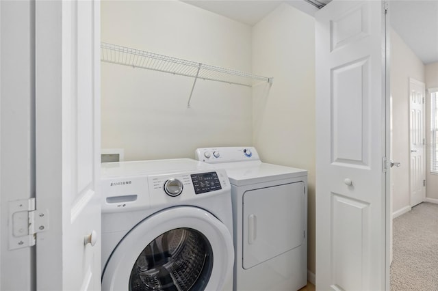 washroom with light carpet and washing machine and clothes dryer