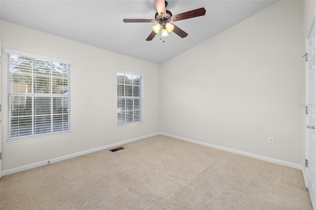 carpeted spare room with ceiling fan