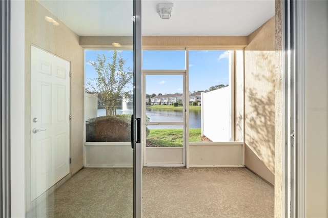 unfurnished sunroom with a water view