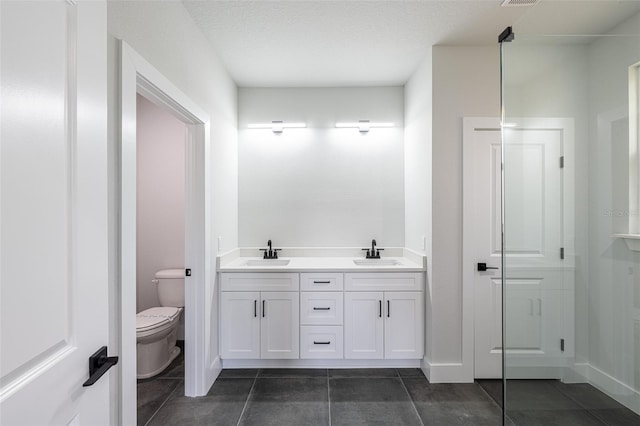 34 Bannbury Ln, Palm Coast, FL 32137 - bathroom featuring tile patterned floors, vanity, toilet, and a textured ceiling