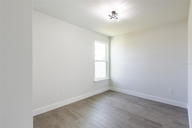 34 Bannbury Ln, Palm Coast, FL 32137 - unfurnished room with dark hardwood / wood-style flooring and a textured ceiling