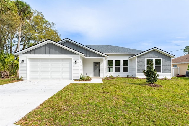 single story home with a garage and a front lawn