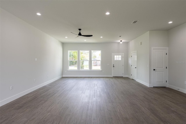 unfurnished living room featuring ceiling fan and dark hardwood / wood-style floors