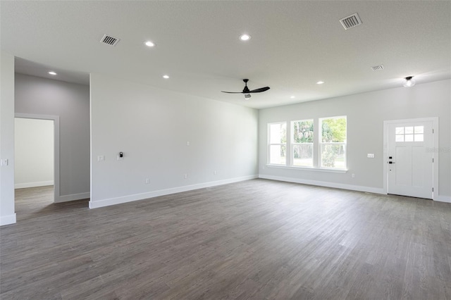 unfurnished living room with wood-type flooring, a textured ceiling, and ceiling fan